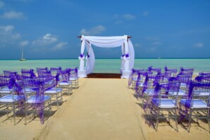 On the beach, white sand, sun loungers, beach umbrellas