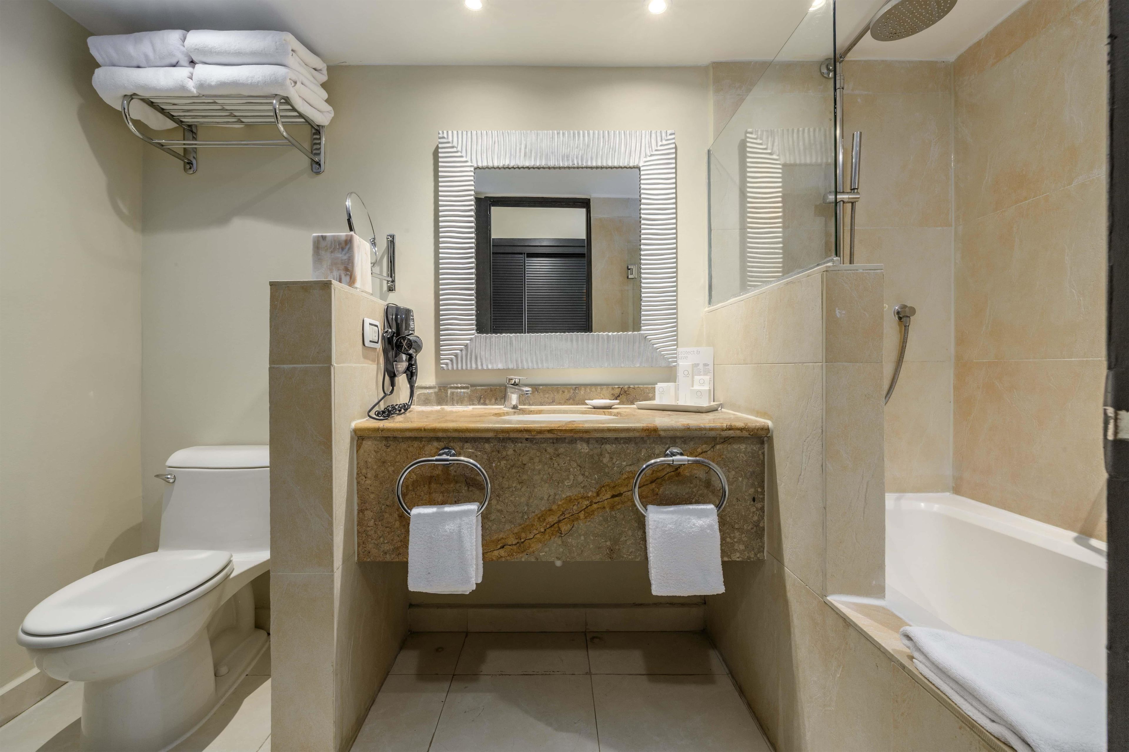 A modern bathroom with a toilet, sink, and shower.