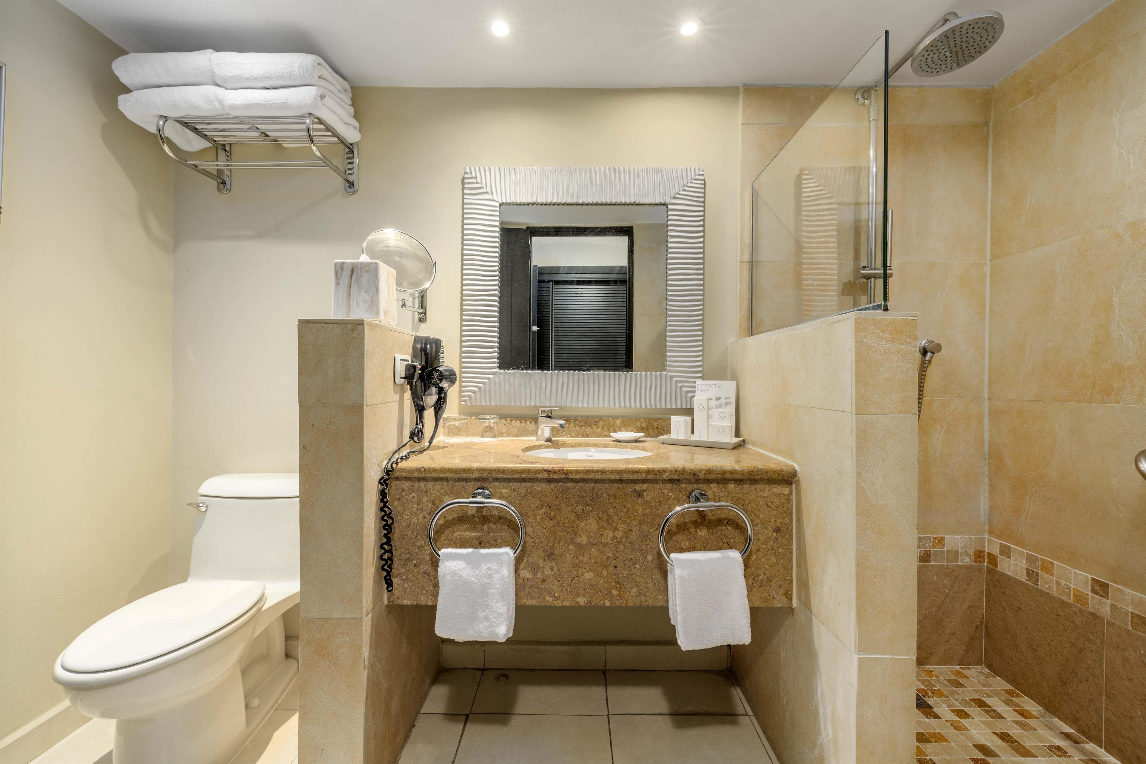 A bathroom with a toilet, sink, and shower.