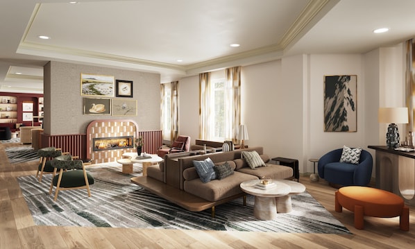 A modern living room with a fireplace, sofas, a coffee table, and a blue armchair. - InterContinental Suites Hotel Cleveland by IHG (Cleveland)