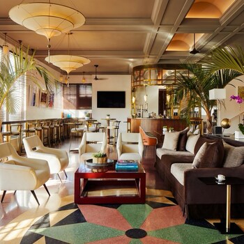 A gym with multiple exercise machines, mirrors, and ceiling lights. at The Betsy - South Beach