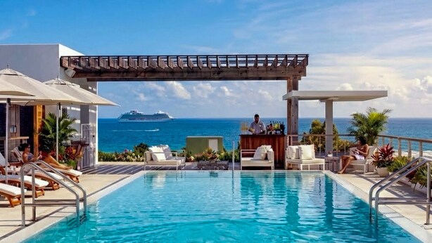 A pool with lounge chairs and a pergola overlooking the ocean. - The Betsy - South Beach (Miami Beach)
