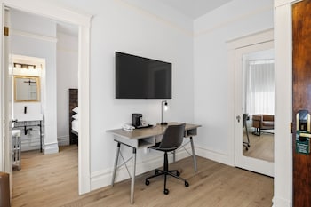 Suite | Living area | 25-inch flat-screen TV with satellite channels, TV, stereo at The Andrews Hotel