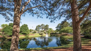 A serene park with a pond, trees, and a fountain. - Club Wyndham Kingsgate (Williamsburg)