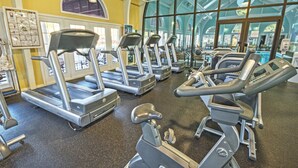 A gym with treadmills, exercise bikes, and a large window providing natural light. - Club Wyndham Kingsgate (Williamsburg)