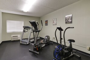 A gym with treadmills, an elliptical, and a stationary bike.