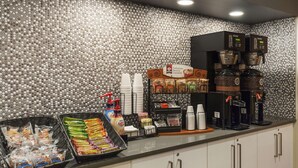A self-service breakfast area with coffee machines, a coffee station, and various food items. - Extended Stay America Premier Suites - Union City - Dyer St. (Union City)