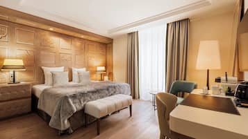 Ein Hotelzimmer mit einem großen Bett, einem Schreibtisch, einem Sessel und einer Couch.