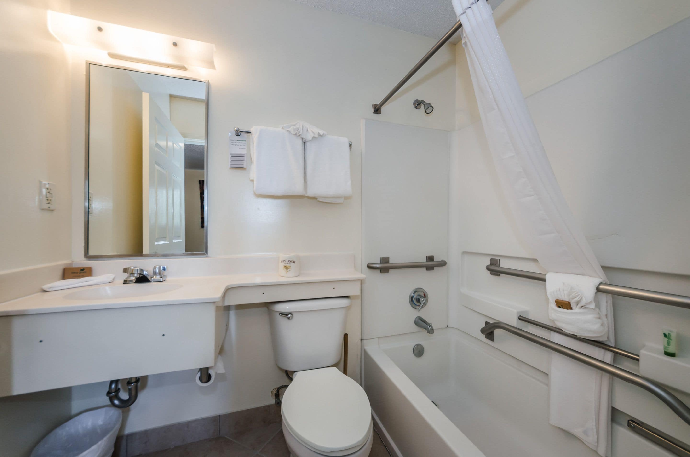 A bathroom with a sink, toilet, and bathtub.