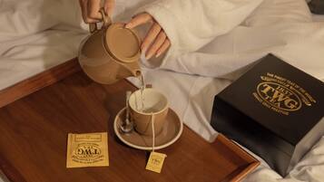 A tray with two cups, a box, and a tag.