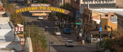 A street view of Golden, Colorado, with a 'Welcome to Golden' sign, buildings, and cars on the road.