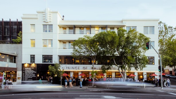 A white building with a sign reading "Prince of Wales Hotel."