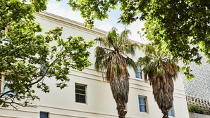 A building with multiple windows and a white facade.