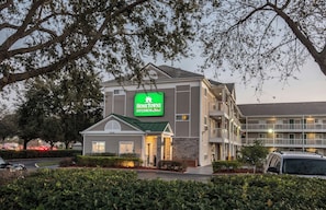 A multi-story building with a sign reading 'Home Towne Studios, Suites.' - HomeTowne Studios by Red Roof Orlando South (Orlando)