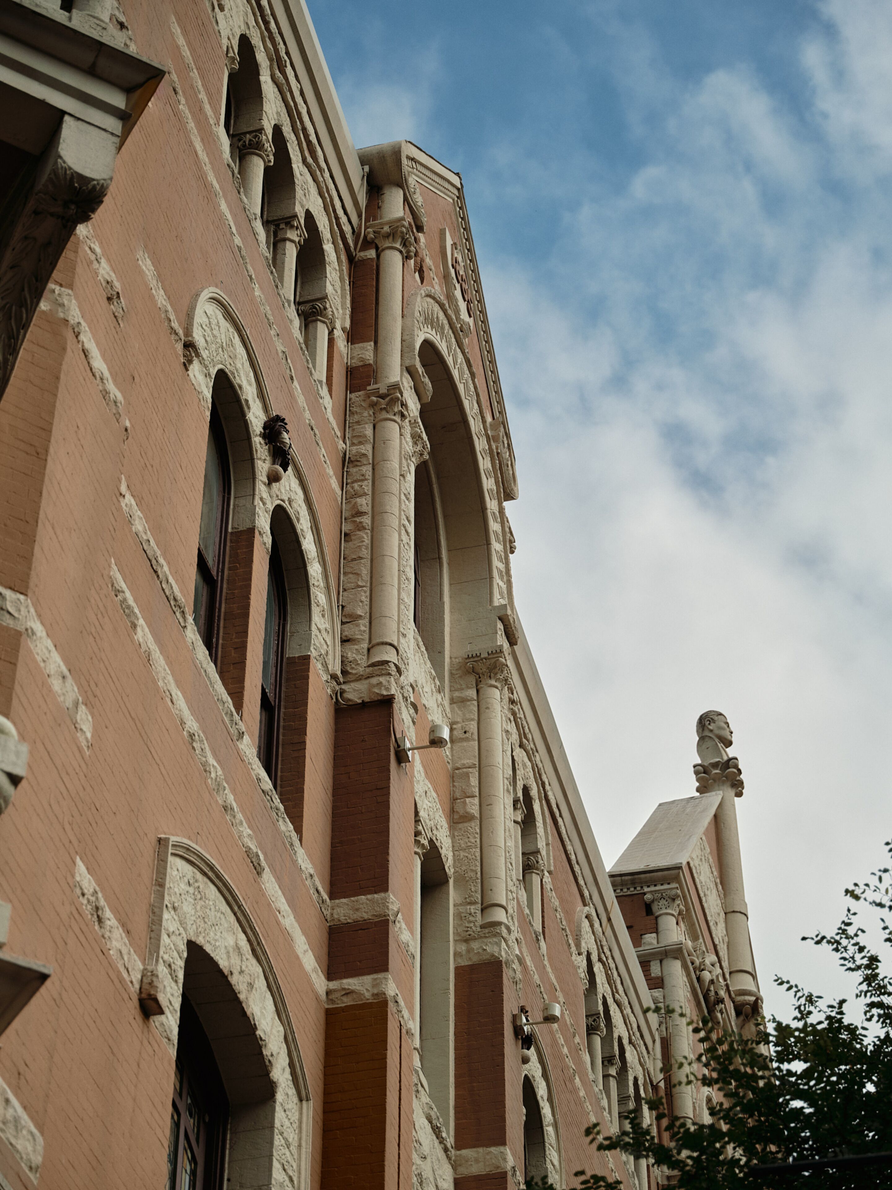 A historic building with arched windows and detailed stonework.