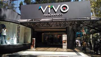 The entrance to Vivo Panoramico with a modern architectural design and glass facade.