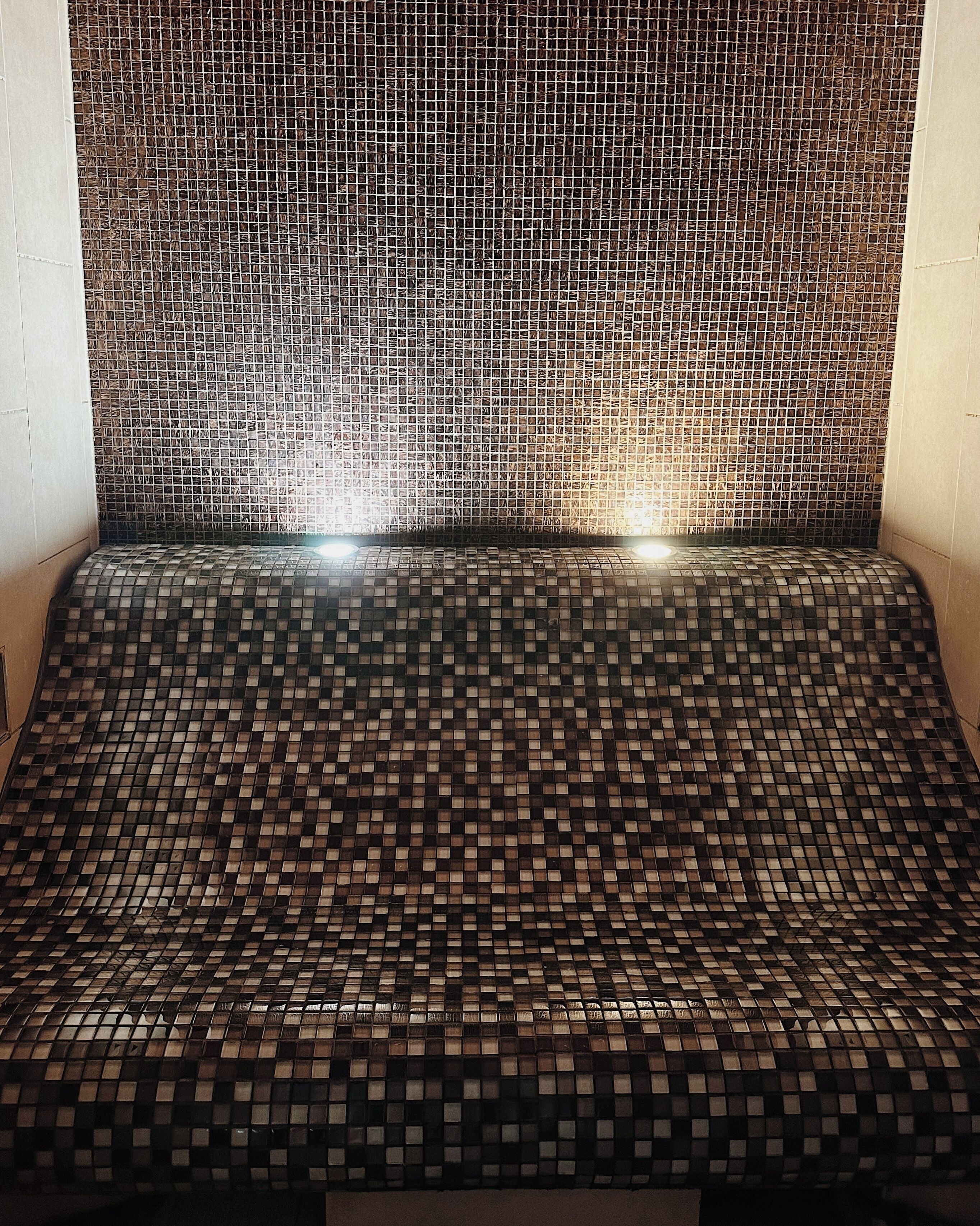 A room with a patterned floor and walls, featuring a grid-like design.
