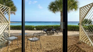 A beachside patio with outdoor seating and a view of the ocean. - Curacao Marriott Beach Resort (Willemstad)