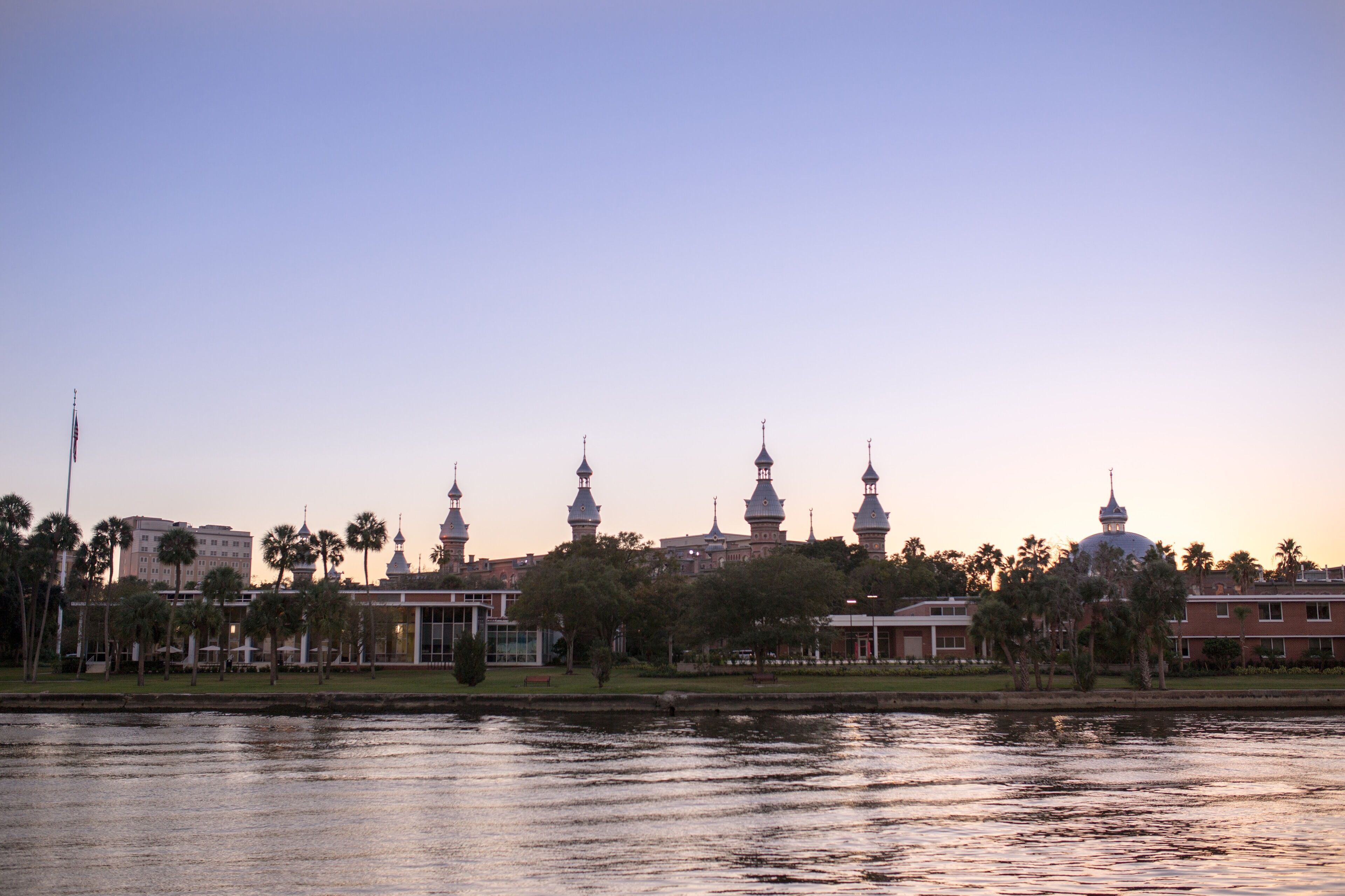 A waterfront view with a row of buildings featuring domed structures and spires, likely a historic or cultural site.
