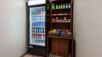 A vending machine stocked with beverages and snacks, including Pepsi, Coca-Cola, and Doritos.
