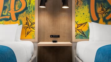 A hotel room with two beds, a nightstand, and a wall with a large letter 'P' and star patterns.