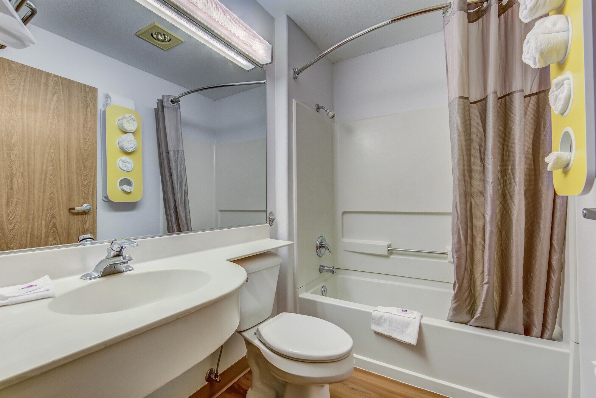 A bathroom with a sink, toilet, and shower.