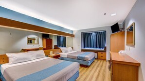 A hotel room with two beds, a desk, a mirror, and a TV. - Motel 6 Sutherlin, OR (Sutherlin)