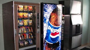 A vending machine with a Pepsi advertisement and a variety of snacks. - Quality Inn & Suites Prestonsburg next to Mountain Arts Center (Prestonsburg)
