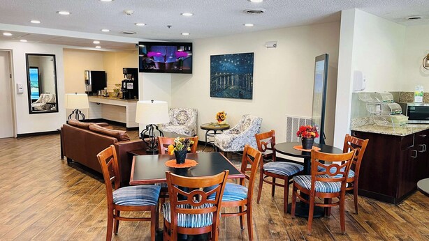 A modern hotel room with a dining area, a living room, and a kitchen. - Quality Inn & Suites Prestonsburg next to Mountain Arts Center (Prestonsburg)
