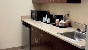 A compact kitchen with a microwave, coffee maker, and a sink. - Quality Inn & Suites Prestonsburg next to Mountain Arts Center (Prestonsburg)