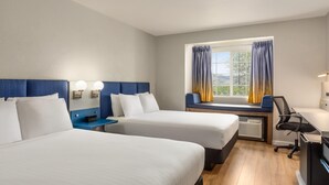 A hotel room with two beds, a desk, a chair, a window with curtains, and a view of the outdoors. - Microtel Inn & Suites by Wyndham Salt Lake City Airport (Salt Lake City)