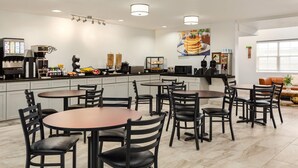 A modern kitchen with a coffee station, multiple seating areas, and a large window. - Microtel Inn & Suites by Wyndham Salt Lake City Airport (Salt Lake City)