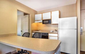 A compact kitchen with a microwave, refrigerator, and a dishwasher. - Studio 6 Corporate Extended Stay Philadelphia Malvern Swedesford Rd. PA (Malvern)
