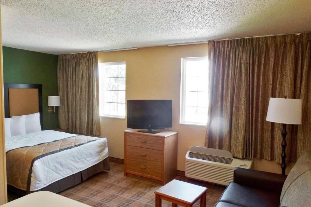 Desk, laptop workspace, blackout drapes, iron/ironing board