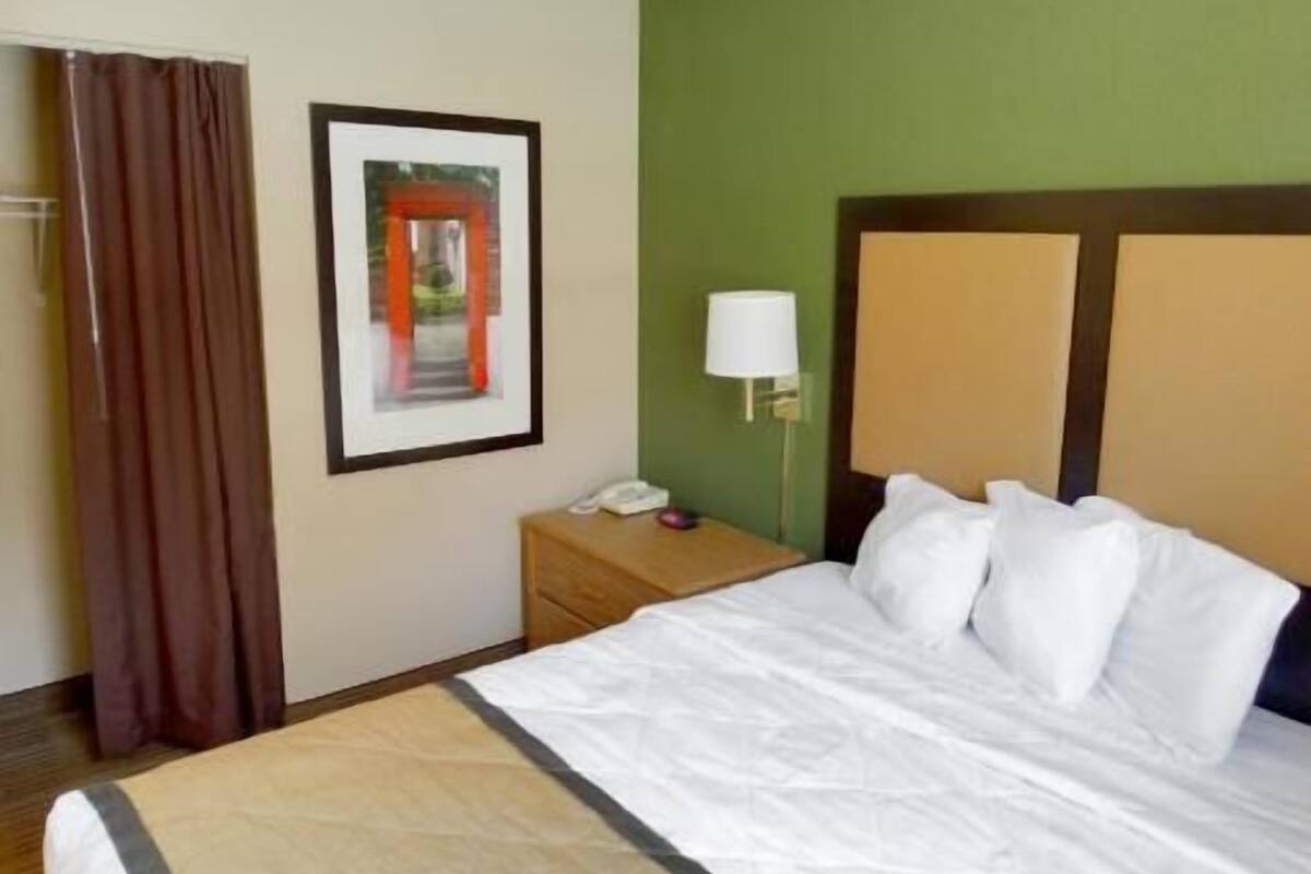 Desk, laptop workspace, blackout drapes, iron/ironing board