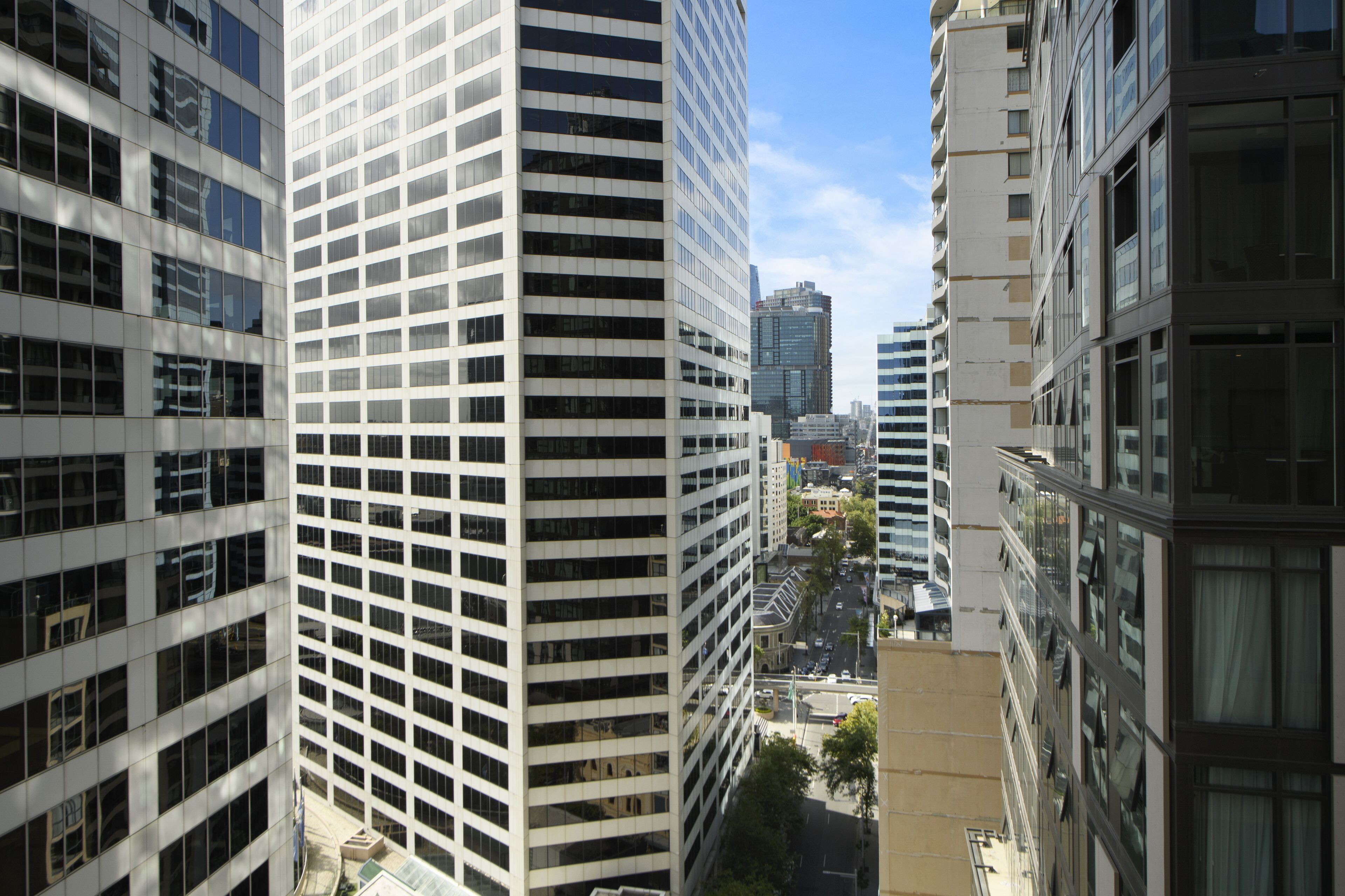 A high-rise building with a grid-like facade and large windows.