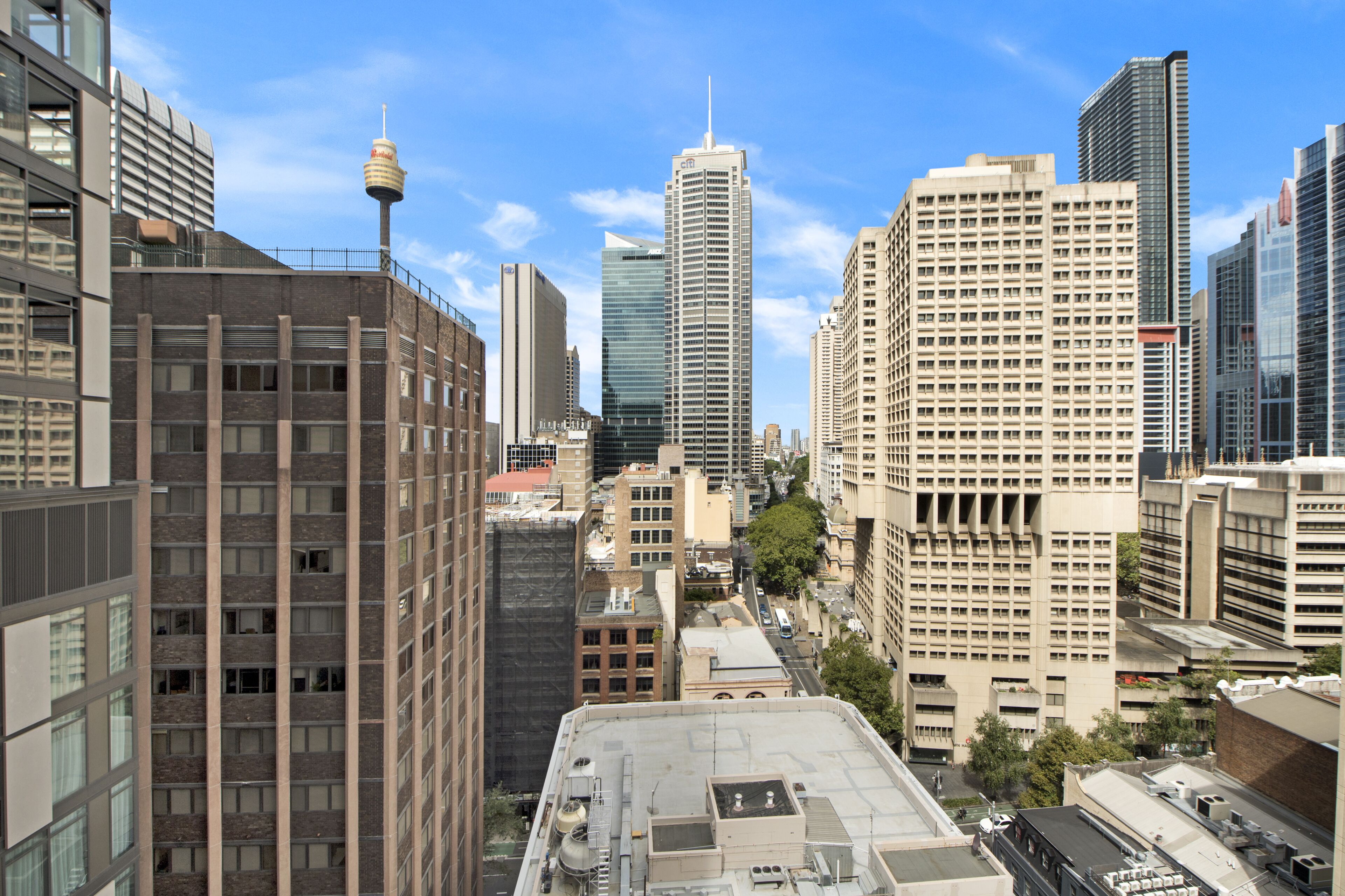 A cityscape with modern high-rise buildings, including a distinctive tower with a spire.