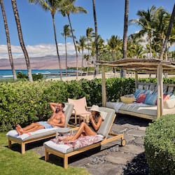 On the beach, white sand, beach cabanas, sun loungers