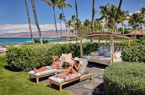 On the beach, white sand, beach cabanas, sun-loungers