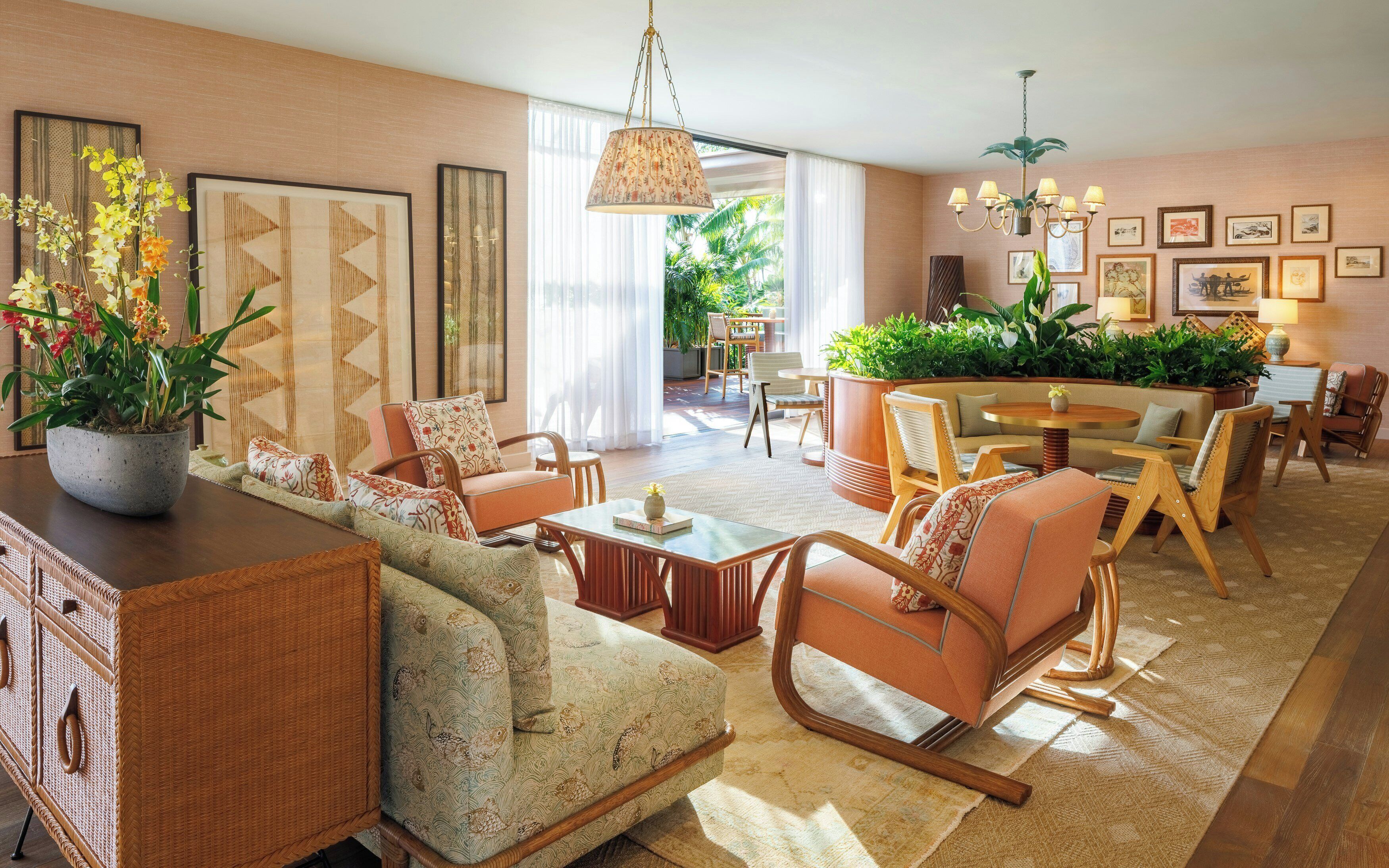 A spacious living room with a sofa, chairs, a dining table, and a large potted plant.