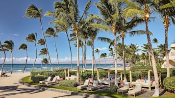 On the beach, white sand, beach cabanas, sun-loungers