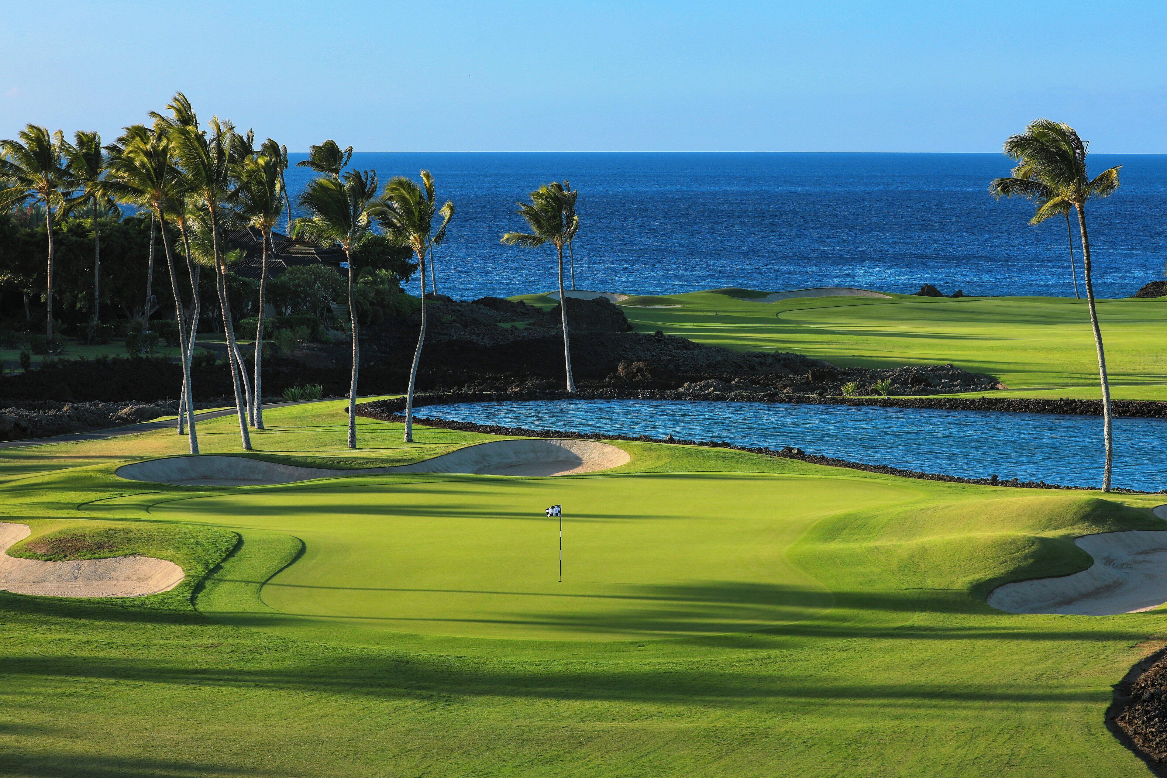A golf course with a view of the ocean.