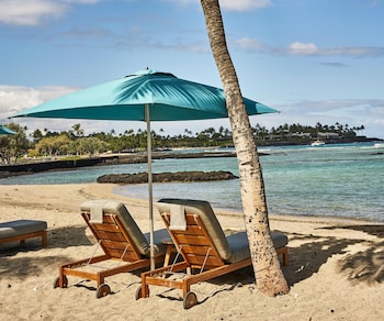 On the beach, white sand, beach cabanas, sun loungers at Mauna Lani, Auberge Resorts Collection