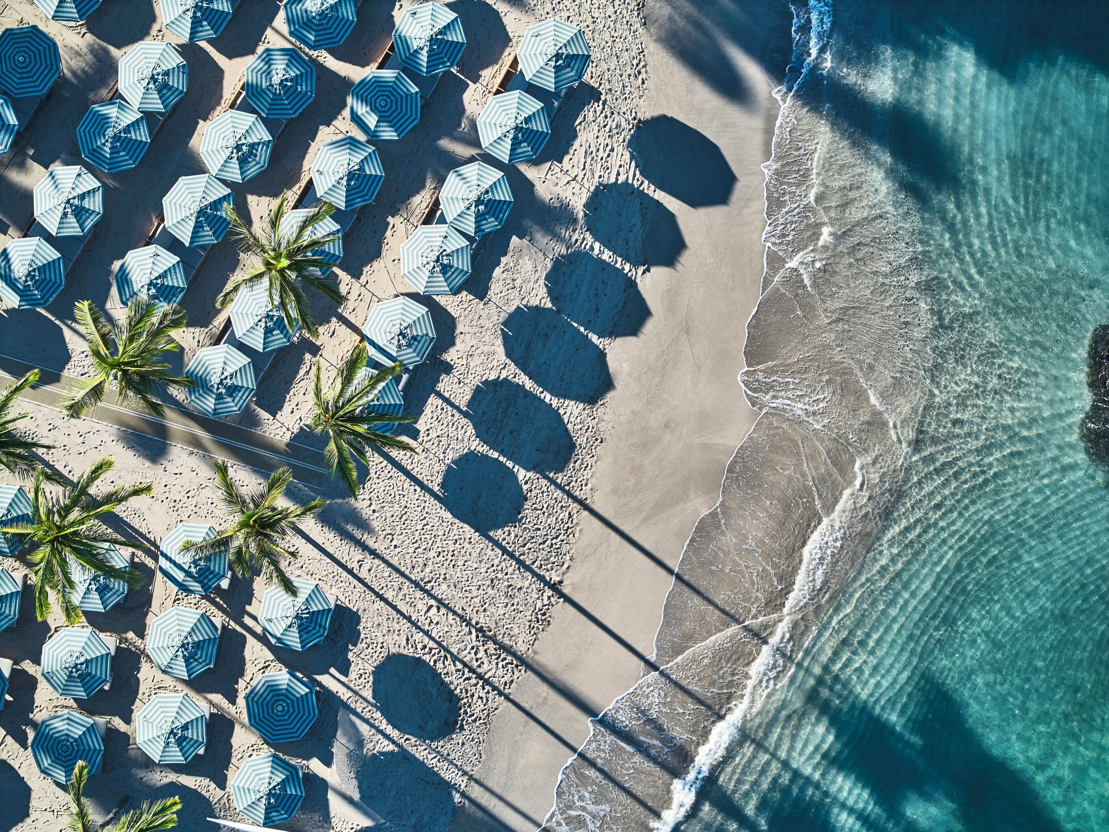On the beach, white sand, beach cabanas, sun-loungers