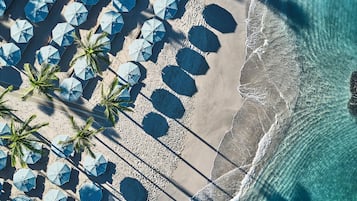 On the beach, white sand, beach cabanas, sun-loungers