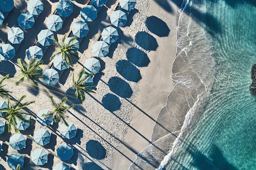On the beach, white sand, beach cabanas, sun-loungers