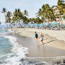On the beach, white sand, beach cabanas, sun loungers