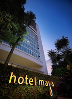 A modern hotel building with a prominent sign reading "hotel maya."