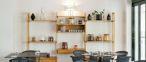 A restaurant interior with wooden shelves, tables, and chairs.
