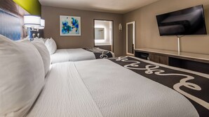 A hotel room with two beds, a TV, a painting, and a bathroom door. - SureStay Plus Hotel by Best Western Point Richmond (Richmond)